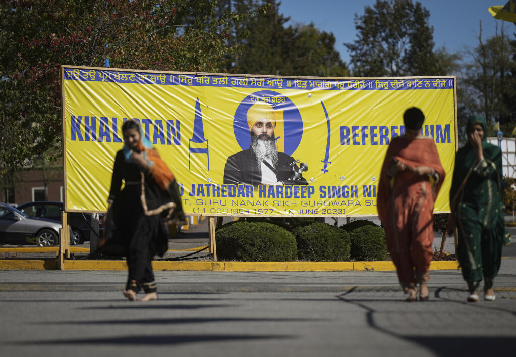 FILE - A banner that shows the late Sikh separatist leader Hardeep Singh Nijjar is displayed outside the Guru Nanak Sikh Gurdwara Sahib in Surrey, British Columbia, Sept. 18, 2023, where he was gunned down in his vehicle while leaving the temple parking lot. Canadian police said Friday, May 3, 2024, that they have made three arrests in the June slaying. (Darryl Dyck/The Canadian Press via AP, File)