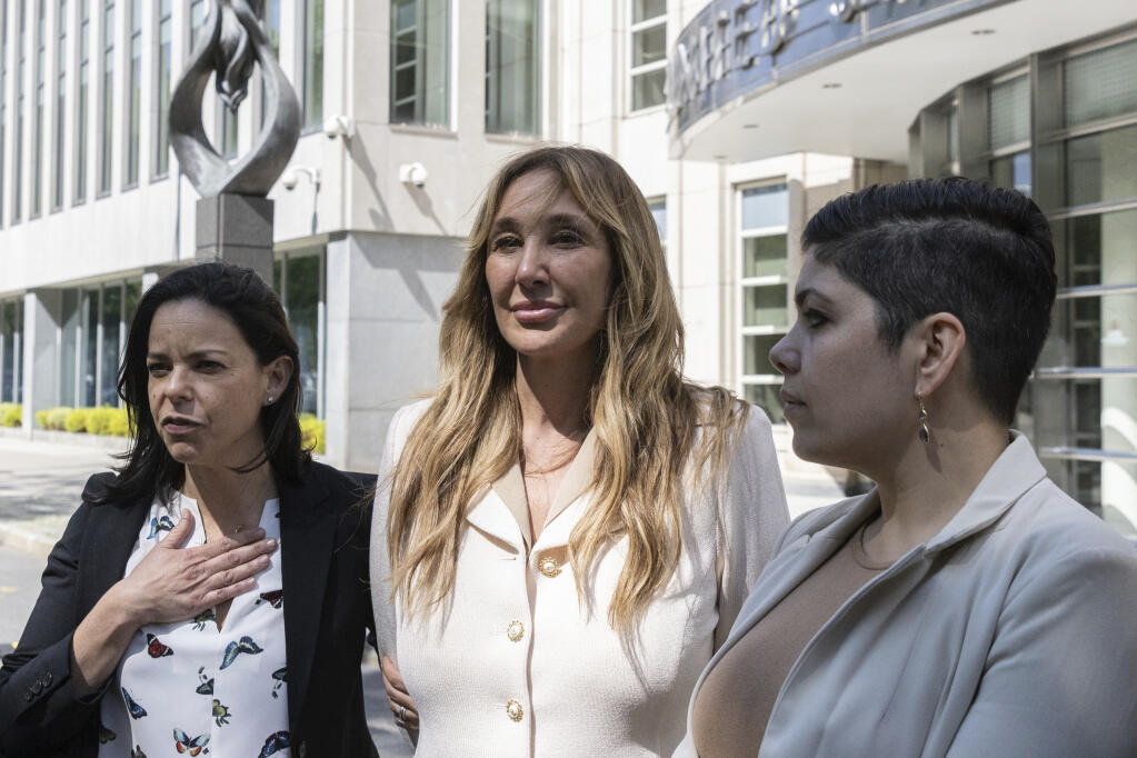 Nicole Daedone, founder and former CEO of OneTaste, center, departs Brooklyn federal court, Tuesday, June 13, 2023, in New York. Daedone, an entrepreneur who promoted group “orgasmic meditation” as a road to women’s well-being, turned herself in and pleaded not-guilty Tuesday to a charge of manipulating traumatized people into debt, undesired sex and underpaid work. (AP Photo/Jeenah Moon)