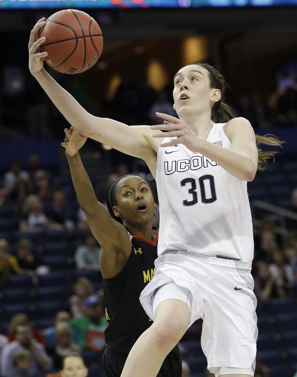 Connecticut forward Breanna Stewart (30) shoots past Maryland guard Shatori Walker-Kimbrough (32) during the second half of the NCAA Women's Final Four semifinal game, Sunday, April 5, 2015, in Tampa, Fla. (AP Photo/John Raoux)