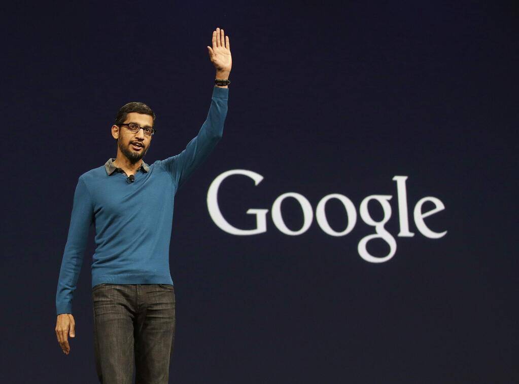 File - In this Thursday, May 28, 2015 file photo, Sundar Pichai, senior vice president of Android, Chrome and Apps, waves after speaking during the Google I/O 2015 keynote presentation in San Francisco. Google is creating a new company, called Alphabet, to oversee its highly lucrative Internet business and a growing flock of other ventures, including some ó like building self-driving cars and researching ways to prolong human life ó that are known more for their ambition than for turning an immediate profit. Pichai will become CEO of Google's core business, including its search engine, online advertising operation and YouTube video service. (AP Photo/Jeff Chiu, File)