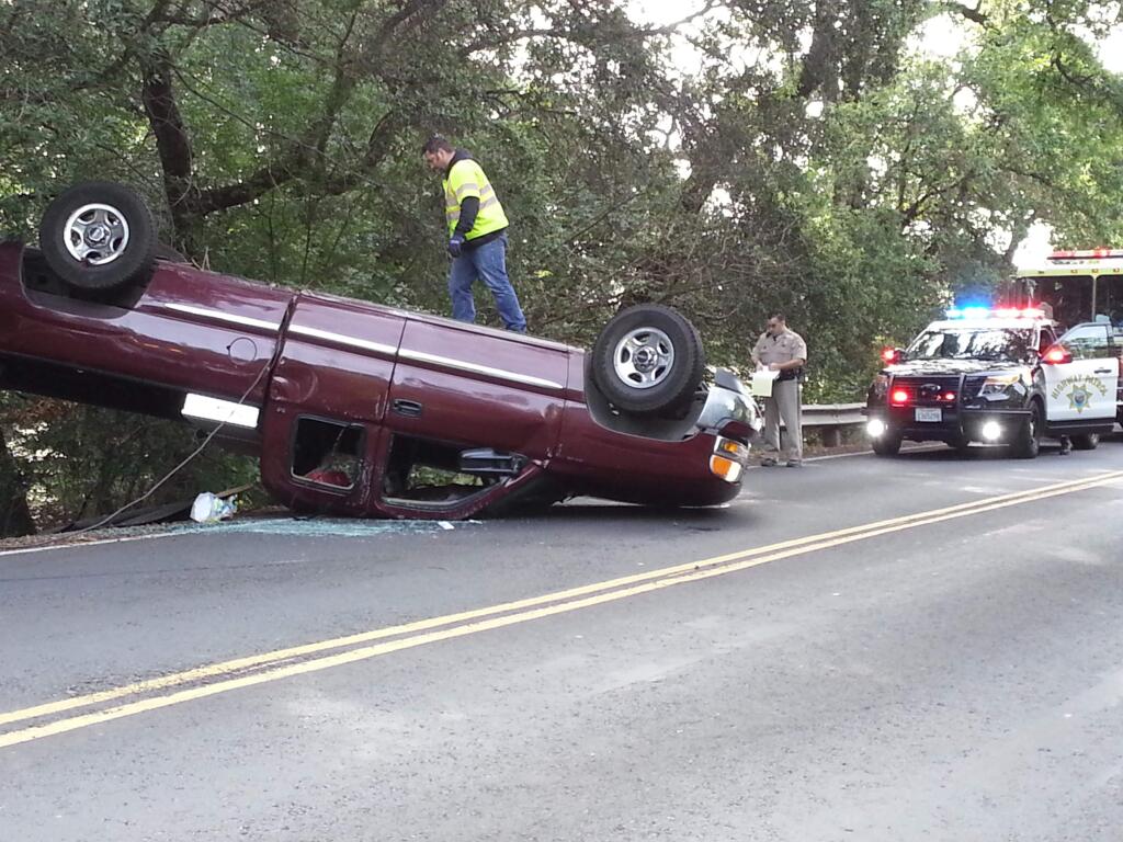 Emergency crews at the scene of a rollover crash on Arnold Drive in Sonoma Valley on Thursday, April 8, 2015. (DEREK MOORE/ PD)