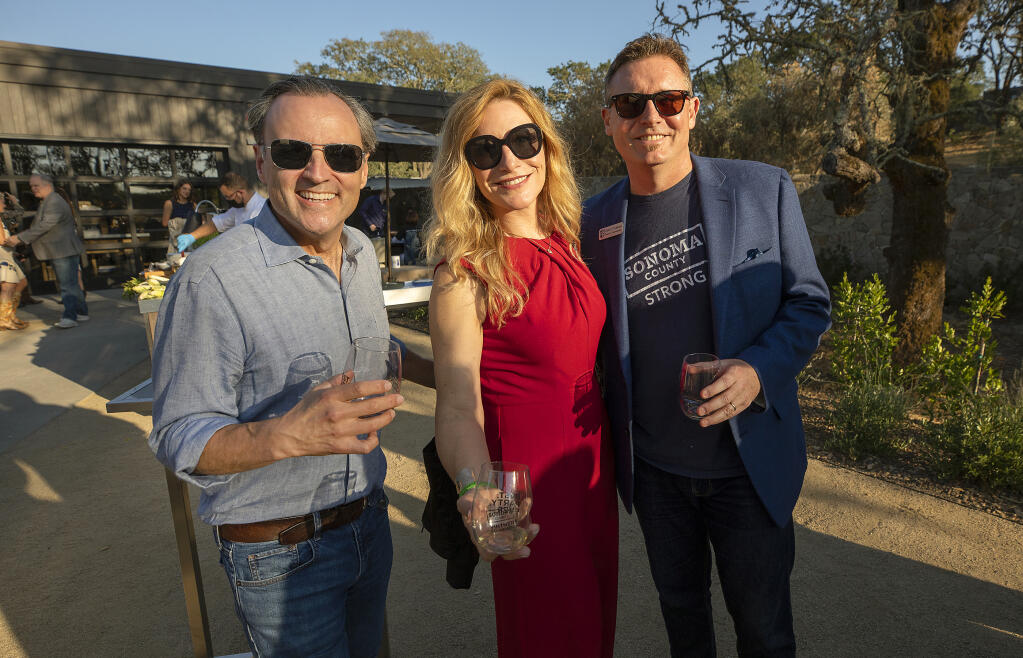 From left, Mark Malpiede from Williams Selyem, Alexandra O'Gorman with Korbel and Christopher O'Gorman with Rodney Strong at the 2021 Sonoma County Wine Auction weekend kickoff party at Montage Healdsburg on Thursday, Sept. 16, 2021. (John Burgess/The Press Democrat)