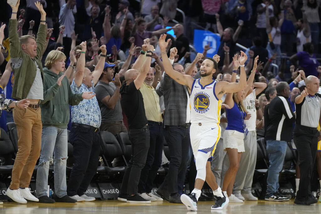 Golden State Warriors guard Stephen Curry celebrates in front of fans after defeating the Sacramento Kings in a preseason game in San Francisco, Wednesday, Oct. 18, 2023. (Jeff Chiu / ASSOCIATED PRESS)