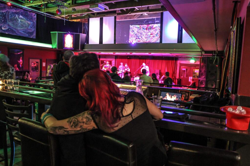 A couple enjoys a night out downtown at Zodiacs on Saturday, February 28, 2015. (Victoria Webb/For The Argus-Courier)