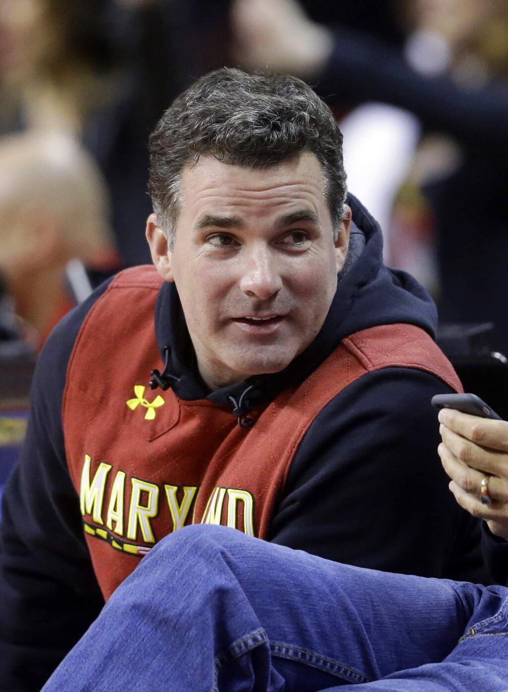 In this Saturday, Jan. 17, 2015 photo, Under Armour founder Kevin Plank sits courtside during the second half of an NCAA college basketball game between Maryland and Michigan State, in College Park, Md. Plank, is responding to criticism he received after calling President Donald Trump 'an asset to the country.' Plank wrote an open letter to Baltimore published as a full-page advertisement in The Baltimore Sun Wednesday, Feb. 15, 2017. (AP Photo/Patrick Semansky)