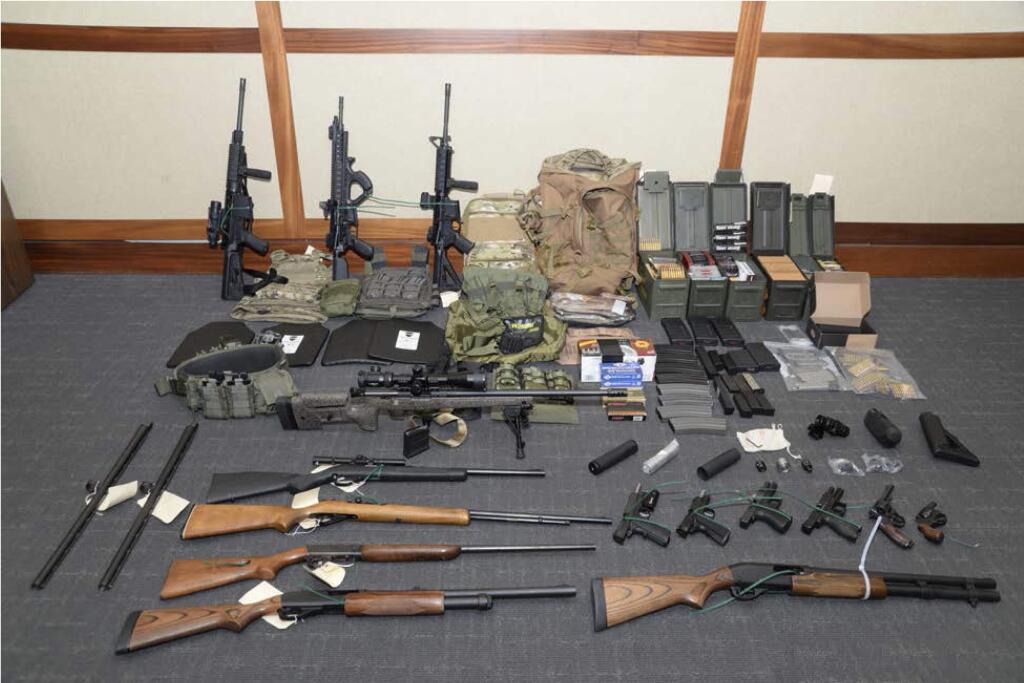 This image provided by the U.S. District Court in Maryland shows a photo of firearms and ammunition that was in the motion for detention pending trial in the case against Christopher Paul Hasson. Prosecutors say that Hasson, a Coast Guard lieutenant is a 'domestic terrorist' who wrote about biological attacks and had a hit list that included prominent Democrats and media figures. He is due in court on Feb. 21 in Maryland. Prosecutors say Hasson espoused extremist views for years. Court papers say Hasson described an 'interesting idea' in a 2017 draft email that included 'biological attacks followed by attack on food supply.' (U.S. District Court via AP)