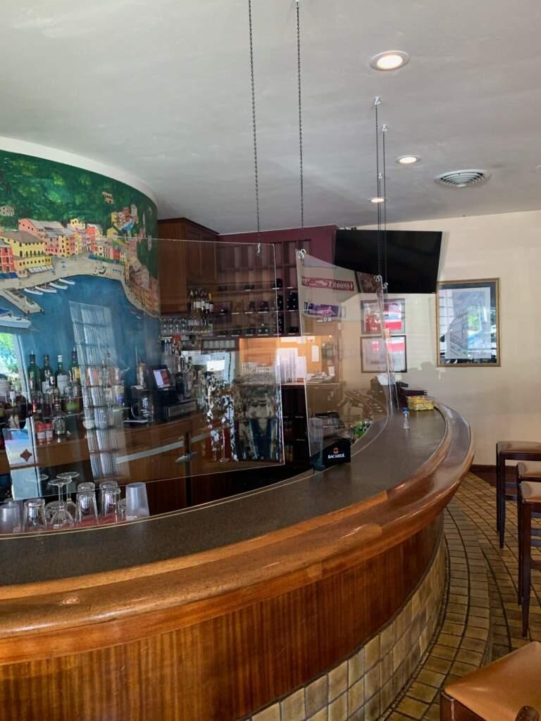 Filippi's Pizza Grotto in Napa installs clear plastic screens as well as dividers between tables as part of protocols to control the spread of Covid-19 after reopening in June 2020 from shelter restrictions. (courtesy photo)