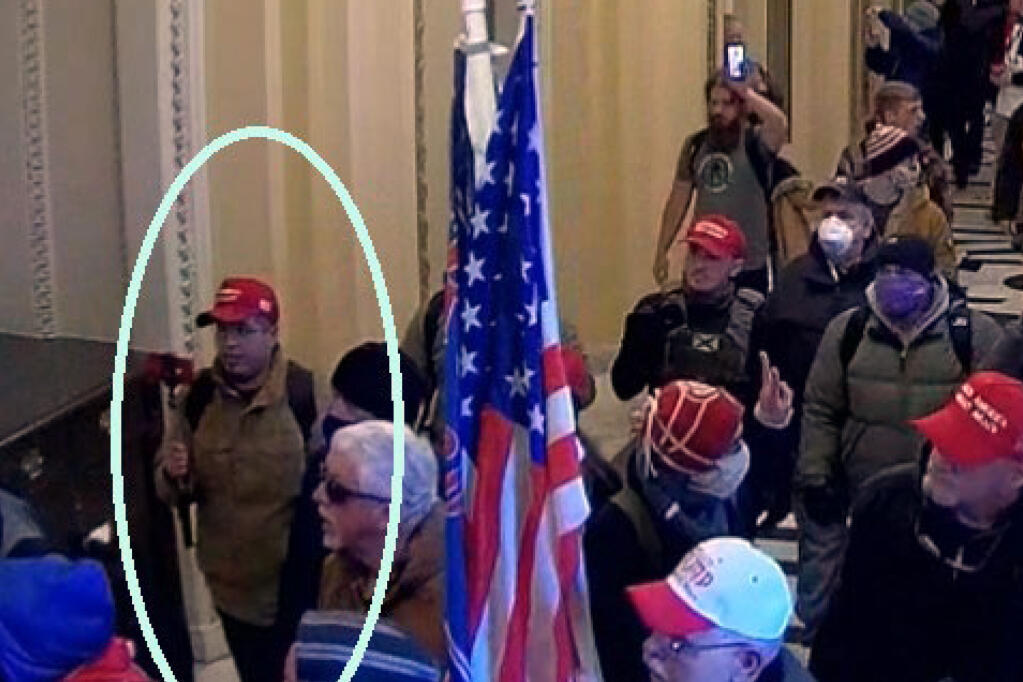 In this image from U.S. Capitol Police video, released and annotated by the Justice Department in the Statement of Facts supporting an arrest warrant, Samuel Montoya, circled in blue, appears on security video inside the U.S. Capitol on Jan. 6, 2021, in Washington. Montoya, a Texas man who worked for conspiracy theorist Alex Jones' website, Infowars, was sentenced on Wednesday, April 5, 2023, to four months of home detention for joining a mob's attack on the U.S. Capitol. (Justice Department via AP)