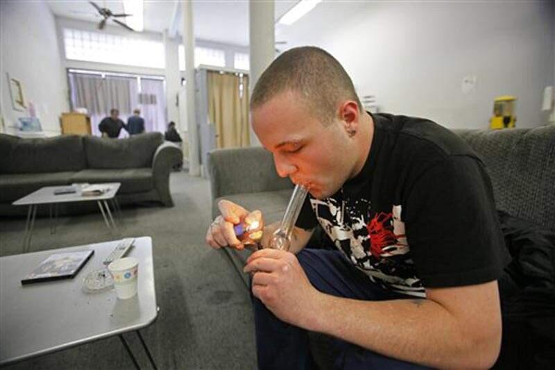 Samuel Bagdorf of San Francisco, who suffers from anxiety disorders, lights his marijuana pipe at the San Francisco Medical Cannabis Clinic in San Francisco, Monday, Oct. 19, 2009. The state Senate on Tuesday passed a bill that would protect pot-smoking employees. Gov. Gavin Newsom has until the end of September to decide whether or not to sign it into law. (AP Photo/Eric Risberg)
