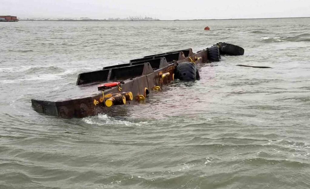 This photo provided by the U.S. Coast Guard shows the 112-foot freight barge Vengeance after capsizing near Yerba Buena Island, Calif., Friday, April 7, 2017. (Petty Officer 3rd Class Sarah Wilson/U.S. Coast Guard via AP)