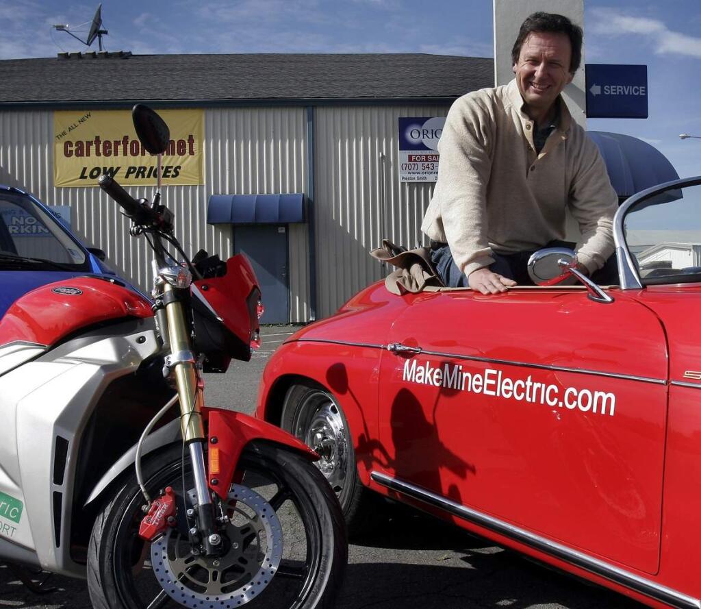 Peter Oliver (shown) and partner Brian Hall are taking over the old Ford dealership site in Sebastopol and are going to sell electrically powered vehicles there. Peter is sitting in a replica sports car that is electrically powered and an electric motorcycle is next to it. February 27, 2009. The Press Democrat / Jeff Kan Lee
