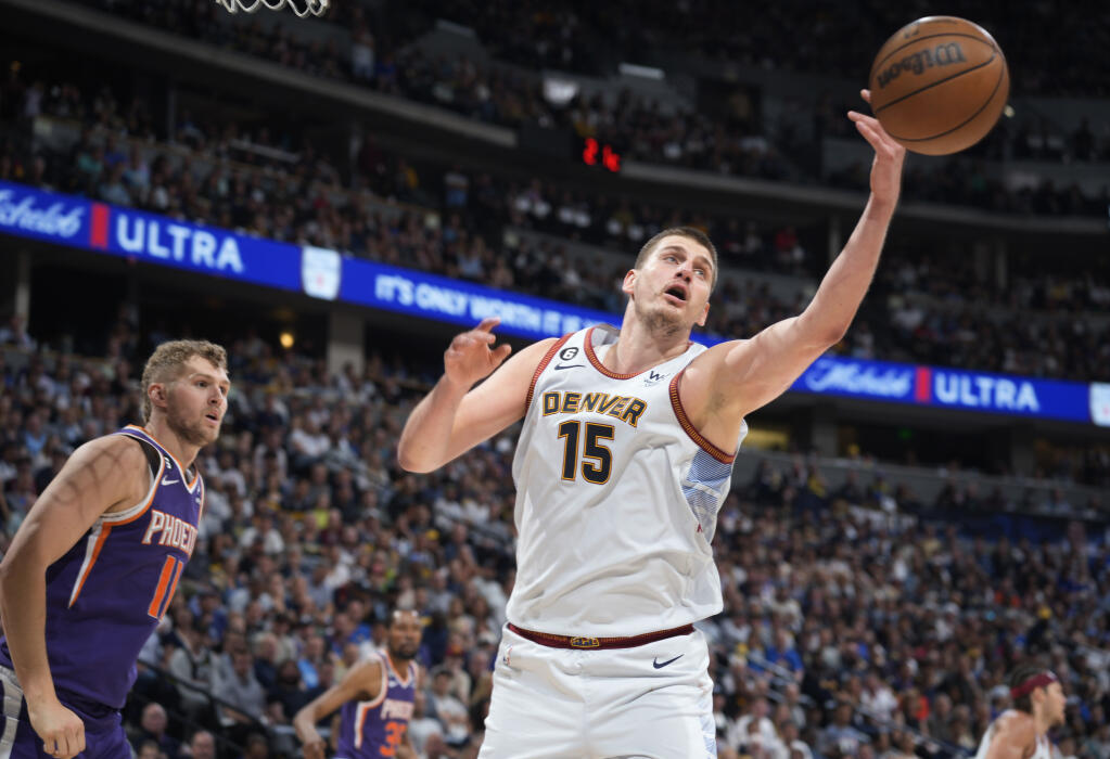 Nuggets center Nikola Jokic, right, reaches for a rebound as Phoenix Suns center Jock Landale watches during the second half of Game 5 of their Western Conference semifinal playoff series Tuesday, May 9, 2023, in Denver. (David Zalubowski / ASSOCIATED PRESS)