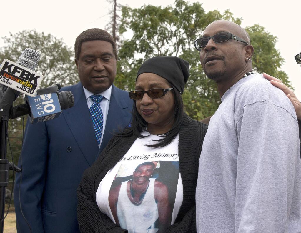 Robert Mann, right, the brother of Joseph Mann, who was killed by Sacramento Police in July, discusses the shooting of his brother during a news conference Monday, Oct. 3, 2016, in Sacramento, Calif. Mann, accompanied by his sister, Deborah, center, and attorney John Burris are demanding that the officers involved in shooting of Joseph Mann, 50, be charged with murder and that the U.S. Department of Justice open a civil rights investigation of the Sacramento Police Department. (AP Photo/Rich Pedroncelli)