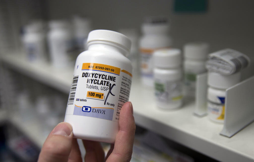 FILE - A pharmacist holds a bottle of the antibiotic doxycycline hyclate in Sacramento, Calif., July 8, 2016. The Centers for Disease Control and Prevention announced Monday, Oct. 2, 2023, that it plans to endorse the antibiotic as a post-sex morning after pill that gay and bisexual men can use to avoid some increasingly common sexually transmitted diseases. (AP Photo/Rich Pedroncelli, File)