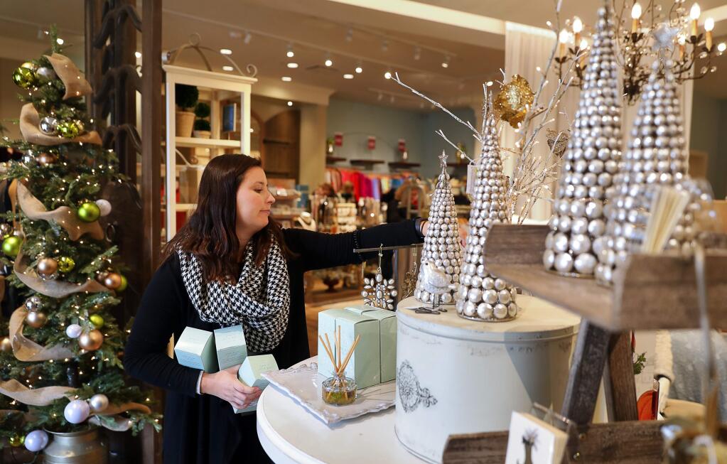 Marisa Parker arranges a display at the Soft Surroundings store in Montgomery Village, in Santa Rosa, Thursday, Nov. 15, 2018. (Christopher Chung / The Press Democrat file)