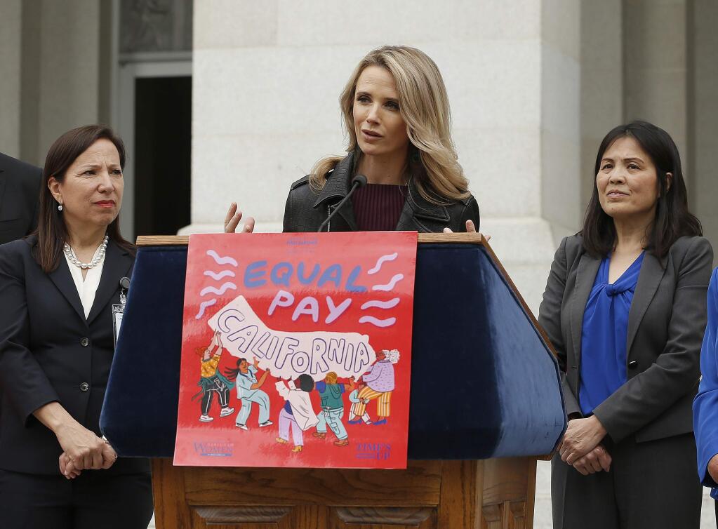 California First Partner Jennifer Siebel Newsom, center, the wife of Gov. Gavin Newsom, calls for equal pay for women during a news conference,Monday, April 1, 2019, in Sacramento, Calif. Siebel Newsom, along with Lt. Gov. Eleni Kounalakis, left, California Labor Secretary Julie, A. Su, right, and others, joined together to announce the #EqualPayCA campaign. (AP Photo/Rich Pedroncelli)