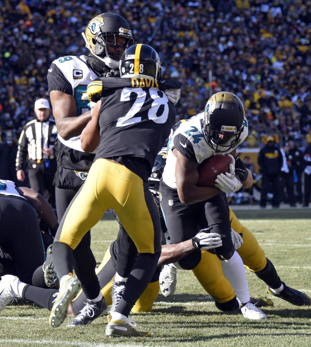 Jacksonville Jaguars running back T.J. Yeldon (24) runs for a touchdown during the first half of an NFL divisional football AFC playoff against the Pittsburgh Steelers game in Pittsburgh, Sunday, Jan. 14, 2018. (AP Photo/Don Wright)