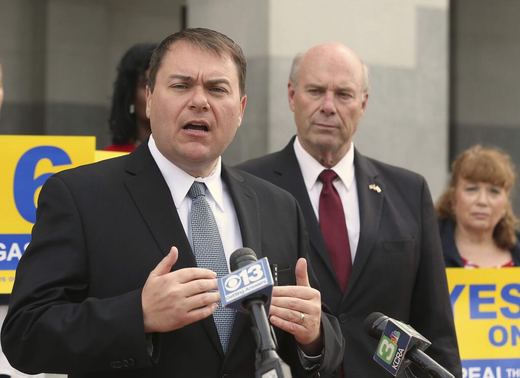 Carl DeMaio, who is leading the Proposition 6 campaign to repeal a recent gas tax said he would attempt to recall Democratic Attorney General Xavier Becerra if the proposition fails, during a news conference, Monday, Oct. 29, 2018, in Sacramento, Calif. DeMaio says that Becerra deceived voters by writing a ballot title that doesn't make clear to voters that Prop. 6 would reduce gas taxes. At right is Republican Attorney General candidate Steven Bailey. (AP Photo/Rich Pedroncelli)
