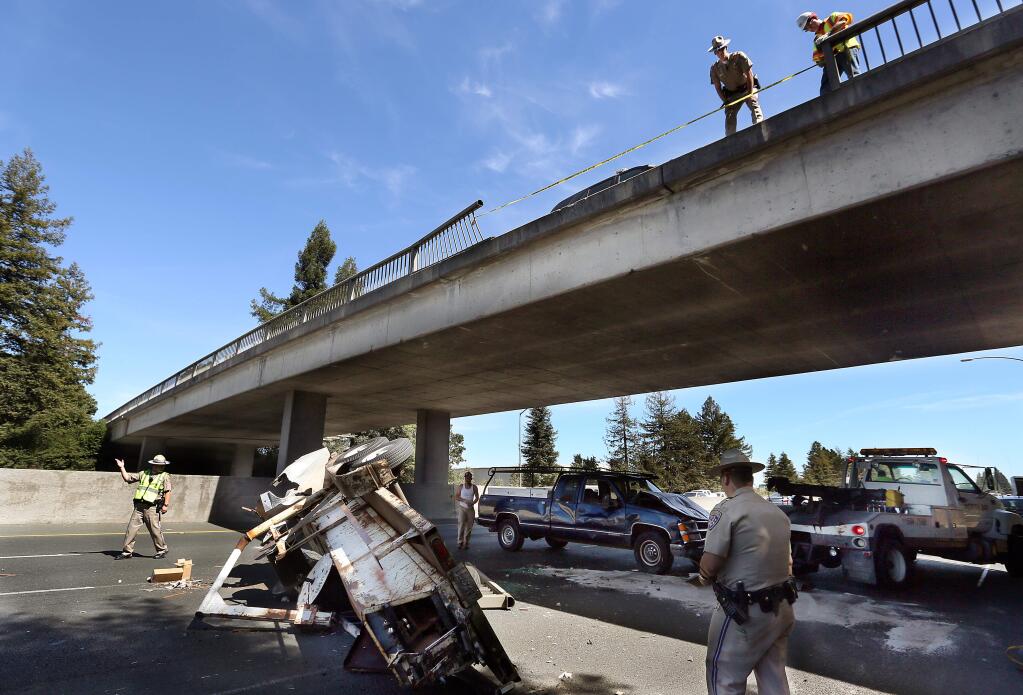 The Rincon Valley Fire Department, California Highway Patrol, Caltrans and the Freeway Service Control cleared the debris after a pickup truck towing a trailer fell off of the Todd Road overpass onto the Southbound lanes of Highway 101 in Santa Rosa, Friday, June 19, 2015. (CRISTA JEREMIASON / The Press Democrat)