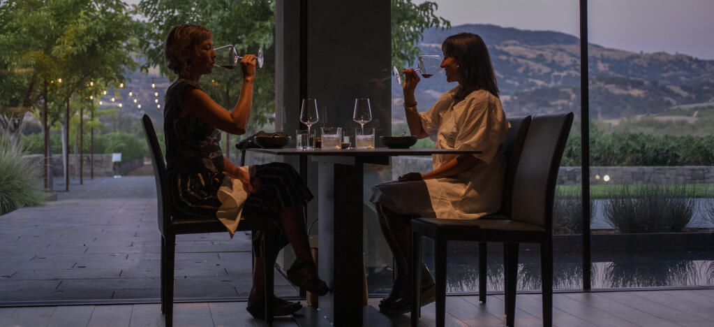 During a family and friends pre-opening night guests enjoy the dining room with sweeping views at sunset of the Alexander Valley at Cyrus in Geyserville on Thursday Sept. 8, 2022. (Chad Surmick/The Press Democrat)