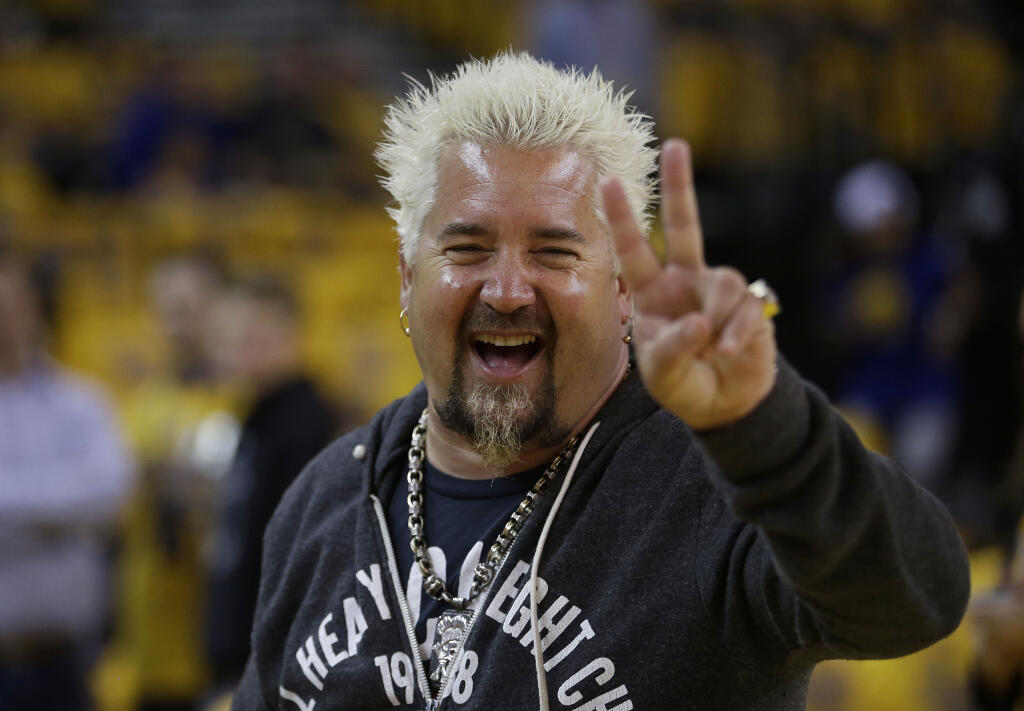Celebrity chef Guy Fieri smiles before Game 2 of the 2015 NBA basketball Western Conference finals. The Food Network chef is planning a major benefit called "Chefs for Maui" on Oct. 21 in Sonoma County with more than 30 of his chef friends. (AP Photo/Rick Bowmer)