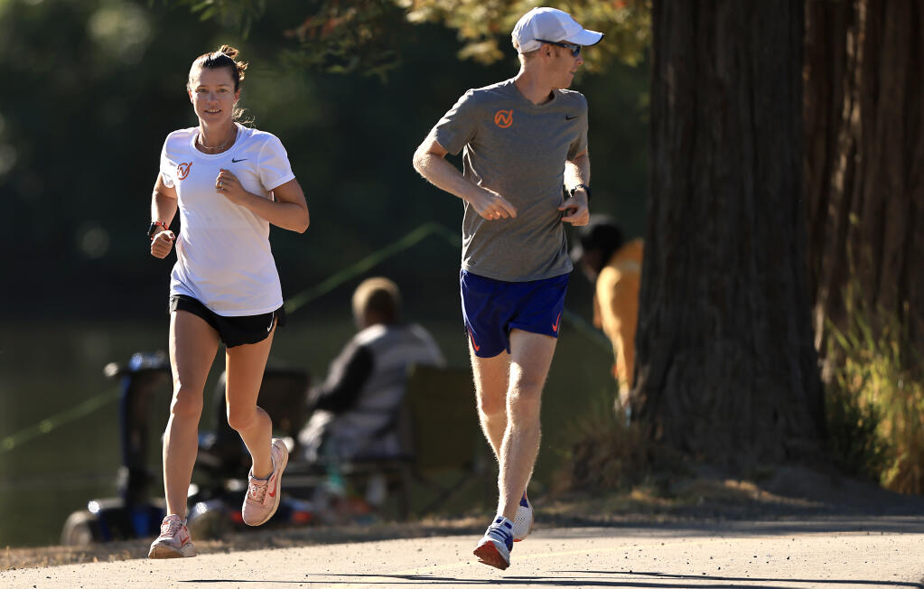 Montgomery High School gradruate and U.S. Olympian Kim Conley, begins an eight-mile training run with her husband and coach, Drew Wartenburg, Saturday, July 15, 2023 at Spring Lake Regional Park in Santa Rosa. Conley is training for the Olympic Marathon trials next February.  (Kent Porter / The Press Democrat)