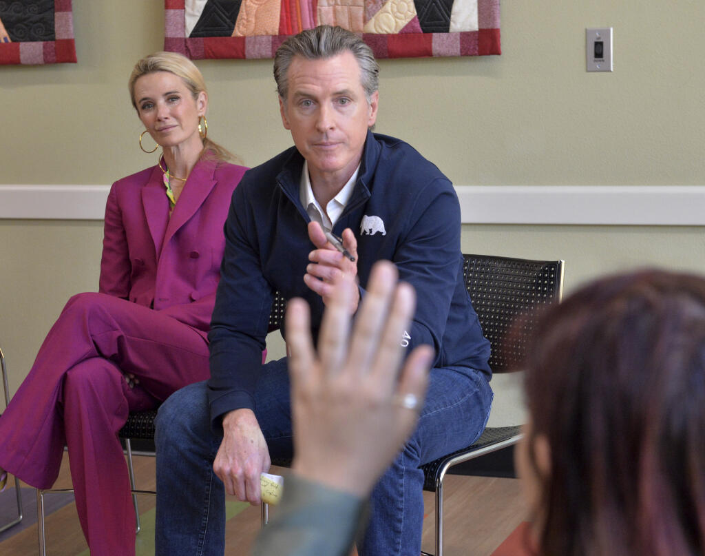 California Gov. Gavin Newsom with first partner Jennifer Newsom, left, calls on a student from New College of Florida on Wednesday, April 6, 2023, during the governor's stop at the Betty J. Johnson North Sarasota Public Library in Sarasota, Fla. Newsom was critical of Florida Gov. Ron DeSantis over his attempt to transform the liberal arts college. (Mike Lang/Sarasota Herald-Tribune via AP)