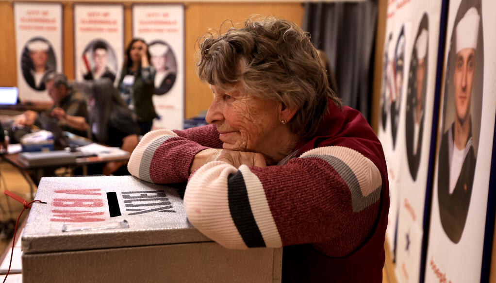 Linda Clapp, an election inspector, waits for a new ballot box to replace the full one she is leaning on, Tuesday, March 5, 2024 at the Cloverdale Veterans Memorial Building. (Kent Porter / Press Democrat) 2024