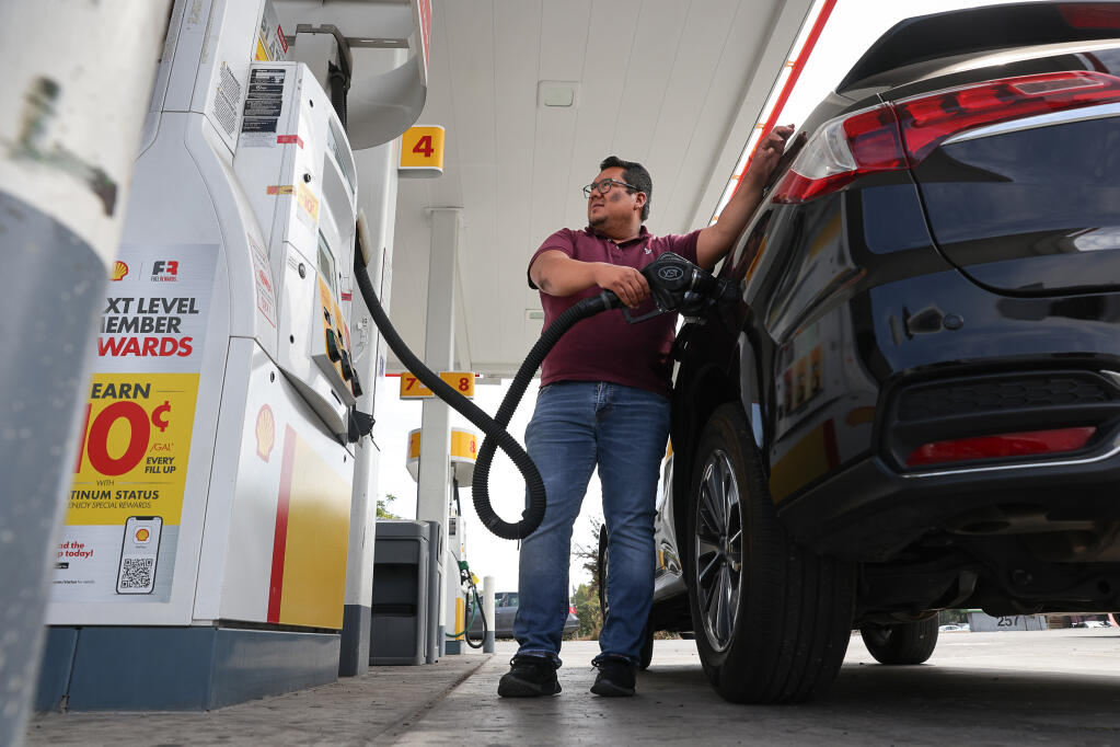 Antonio Fuentes fills up his vehicle with gas at the Shell gas station on Dutton Avenue, near the Highway 12 onramp, in Santa Rosa, Thursday, Aug. 31, 2023.  (Christopher Chung / The Press Democrat)