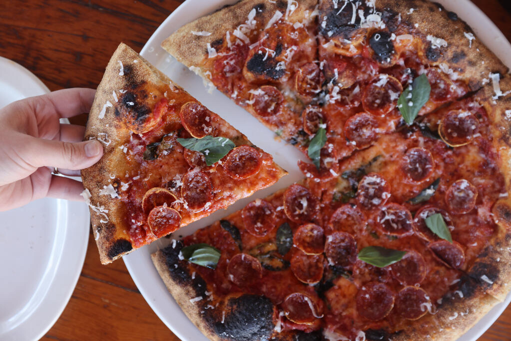 Pepperoni pizza with basil and drizzled with spicy honey at Ciccio in Yountville, Monday, July 10, 2023. (Beth Schlanker / The Press Democrat)