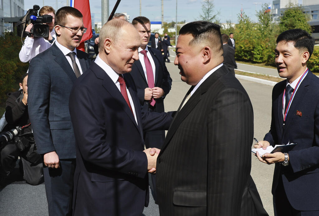 Russian President Vladimir Putin, left, and North Korea's leader Kim Jong Un shake hands during their meeting at the Vostochny cosmodrome outside the city of Tsiolkovsky, about 200 kilometers (125 miles) from the city of Blagoveshchensk in the far eastern Amur region, Russia, on Wednesday, Sept. 13, 2023. (Vladimir Smirnov, Sputnik, Kremlin Pool Photo via AP)