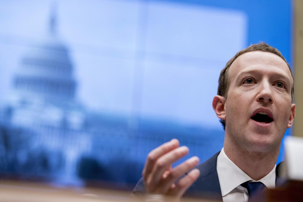 FILE - In this April 11, 2018 file photo, Facebook CEO Mark Zuckerberg testifies before a House Energy and Commerce hearing on Capitol Hill in Washington. Facebook faces a rough road ahead with Libra, but defections by high-profile partners are still unlikely to spell the end for the digital currency. On Friday, Oct. 11, 2019, Visa and MasterCard announced their departures from the Libra project, as did e-commerce giant eBay and payments startup Stripe. (AP Photo/Andrew Harnik, File)