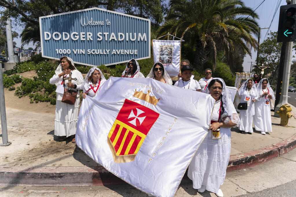 Church members from Riverside pray outside Dodger Stadium while marching to a nearby church Friday, June 16, 2023, in Los Angeles. (Jae C. Hong / ASSOCIATED PRESS)