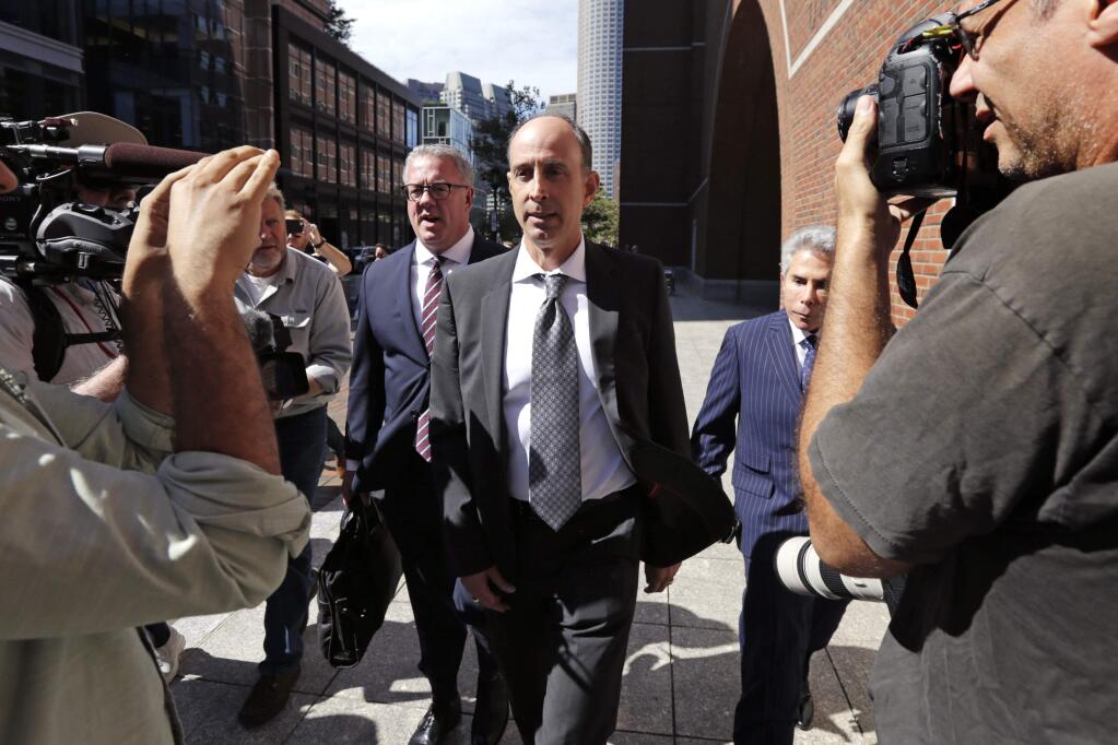 California businessman Stephen Semprevivo departs after his sentencing hearing at federal court in Boston, Thursday, Sept. 26, 2019. Semprevivo, who plead guilty to charges that he bribed the Georgetown tennis coach to get his son admitted to the school during May 2019, was sentenced Thursday to four months in prison. (AP Photo/Charles Krupa)