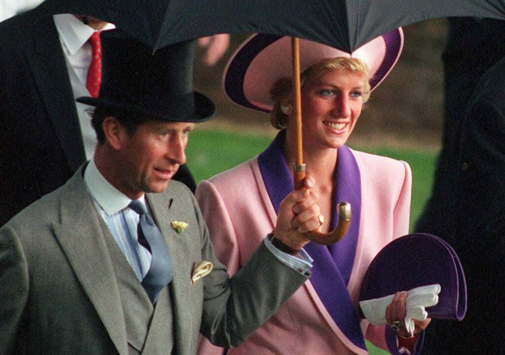 FILE- In this Wednesday, June 20, 1990 file photo, Britain's Princess Diana and Prince Charles, take shelter under an umbrella while attending the second day of the Royal Ascot horse race meet near London. A British television channel is broadcasting a new documentary on Princess Diana using video tapes in which she candidly discussed her marital problems and her strained relationship with the royal family. (AP Photo/Martyn Hayhow, File)