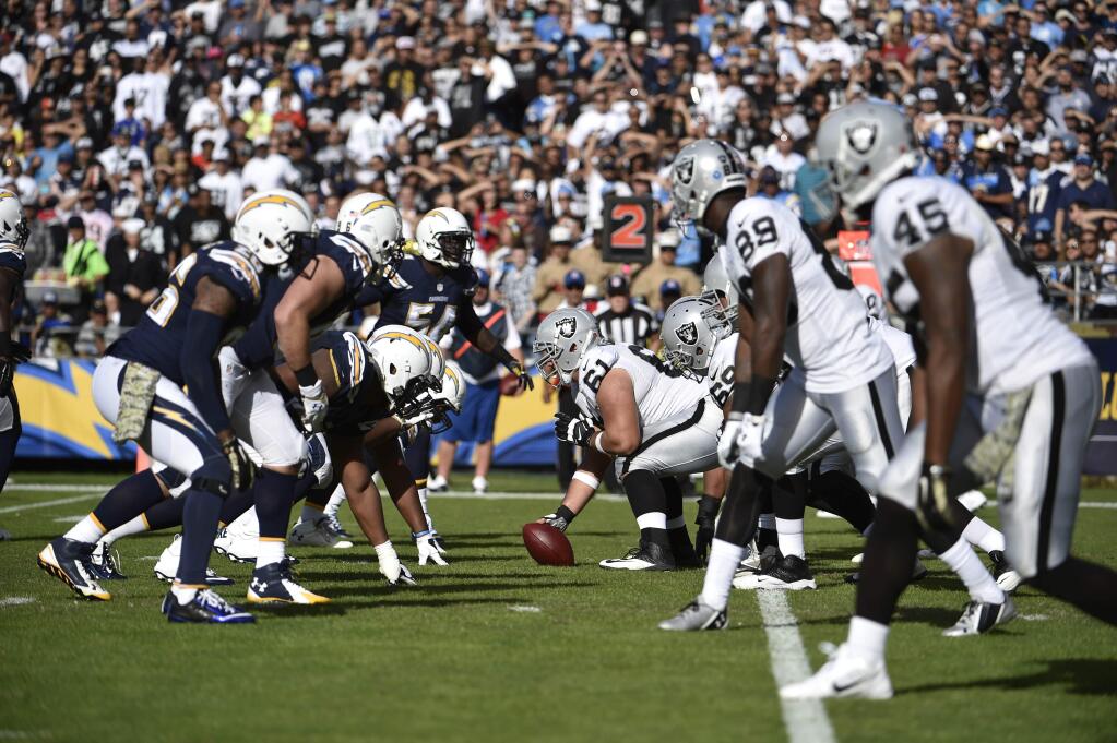 In this Sunday, Nov. 16, 2014 file photo,The Oakland Raiders and San Diego Chargers face off against each other during the second half of agame in San Diego. The Oakland Raiders and San Diego Chargers are planning a shared stadium in the Los Angeles area if both teams fail to get new stadium deals in their current hometowns. The teams announced plans for the $1.7 billion stadium in Carson in a joint statement Thursday night, Feb. 19, 2015. (AP Photo/Denis Poroy, File)