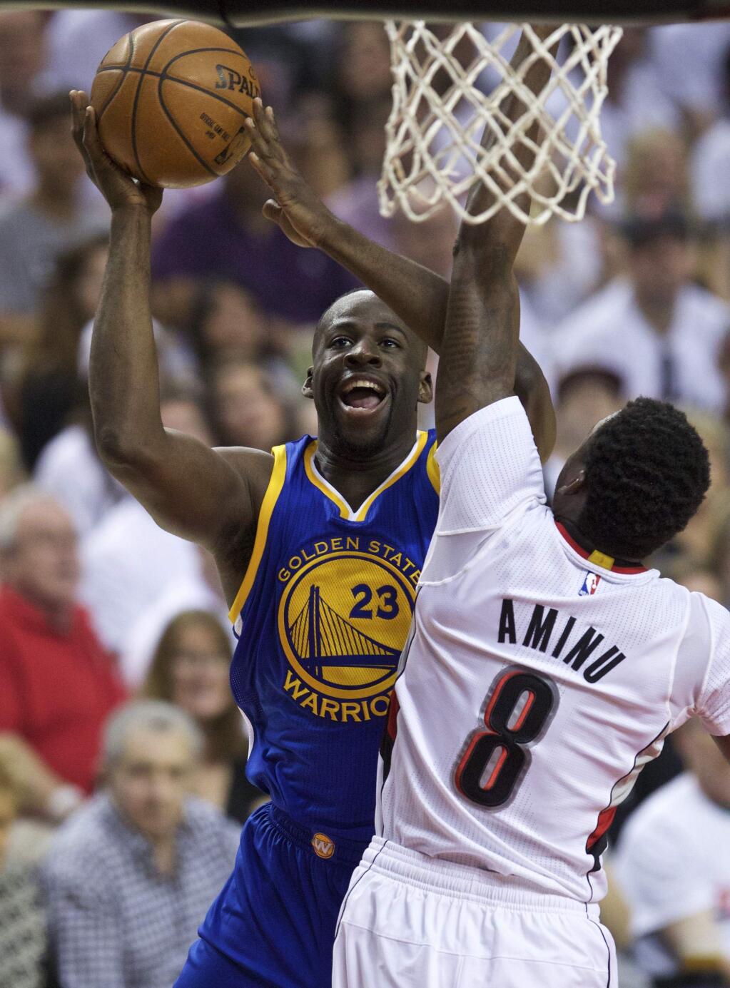 Golden State Warriors forward Draymond Green, left, shoots over Portland Trail Blazers forward Al-Farouq Aminu, right, during the first half of Game 3 of an NBA basketball second-round playoff series Saturday, May 7, 2016, in Portland, Ore. (AP Photo/Craig Mitchelldyer)