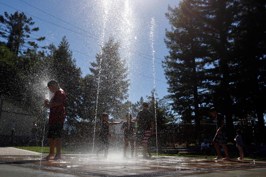 Children cool off in the water feature at Prince Gateway Park in Santa Rosa on Tuesday, May 2, 2017. (ALVIN JORNADA/ PD FILE)