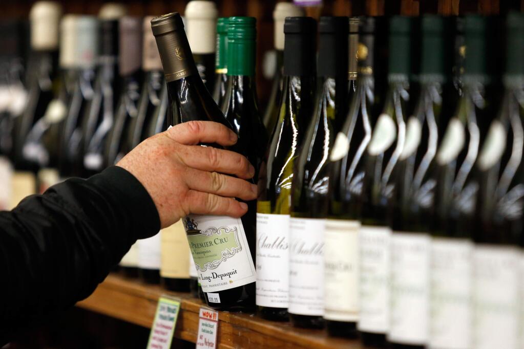 Vineyard manager Danny Smith browses the display of French wines at Bottle Barn in Santa Rosa on Wednesday, Jan. 24, 2018. Wine shipments in volume increased 1.3% and overall wine sales increased almost 3% last year, according to the Unified Wine and Grape Symposium. (Alvin Jornada / The Press Democrat)