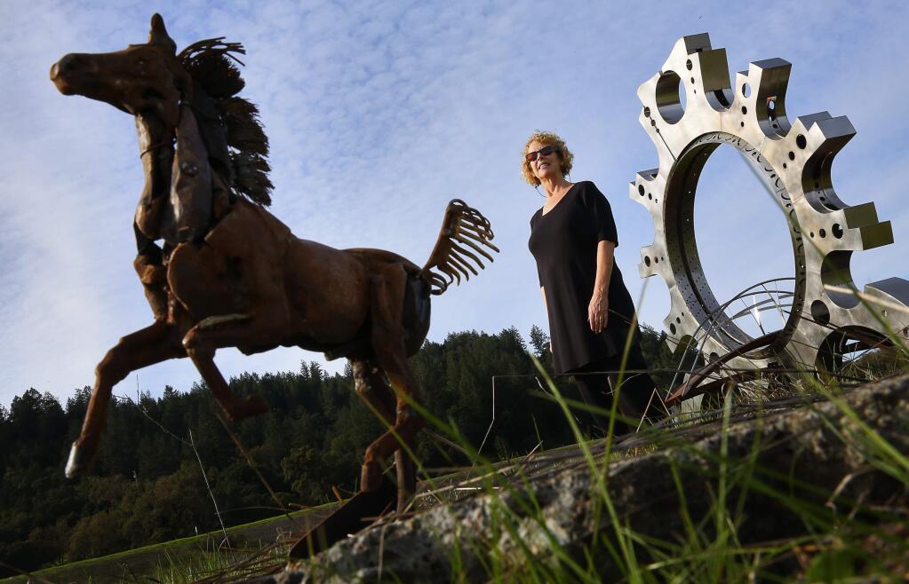 Victoria Heiges is the Geyserville Sculpture Trail manager for the Geyserville Community Foundation, which wants to raise $100,000 to install a galloping horse sculpture by Bryan Tedrick. Tedrick built the 13-inch model on the left. The full-sized sculpture wil be approximately 25-feet high.(Christopher Chung/ The Press Democrat)