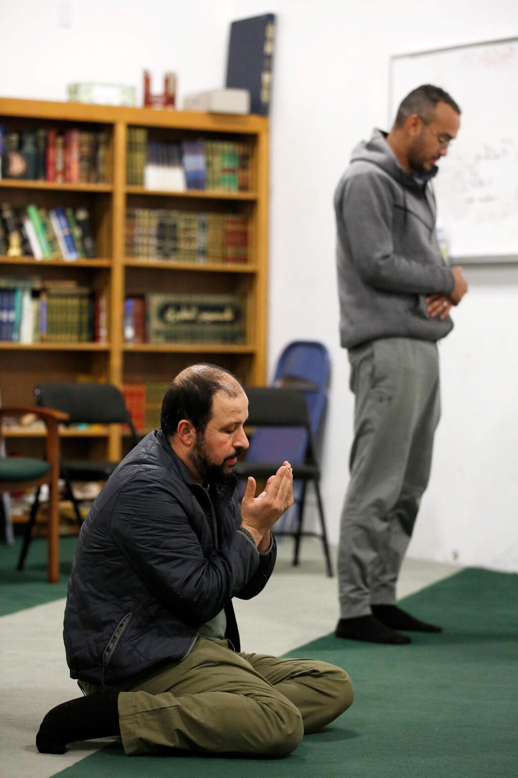 Houssine Latrache, left, and Abdul Amri offer voluntary prayers after Isha, a nightly Muslim prayer service, at the Islamic Society of Santa Rosa in Santa Rosa, California, on Saturday, March 16, 2019. (Alvin Jornada / The Press Democrat)