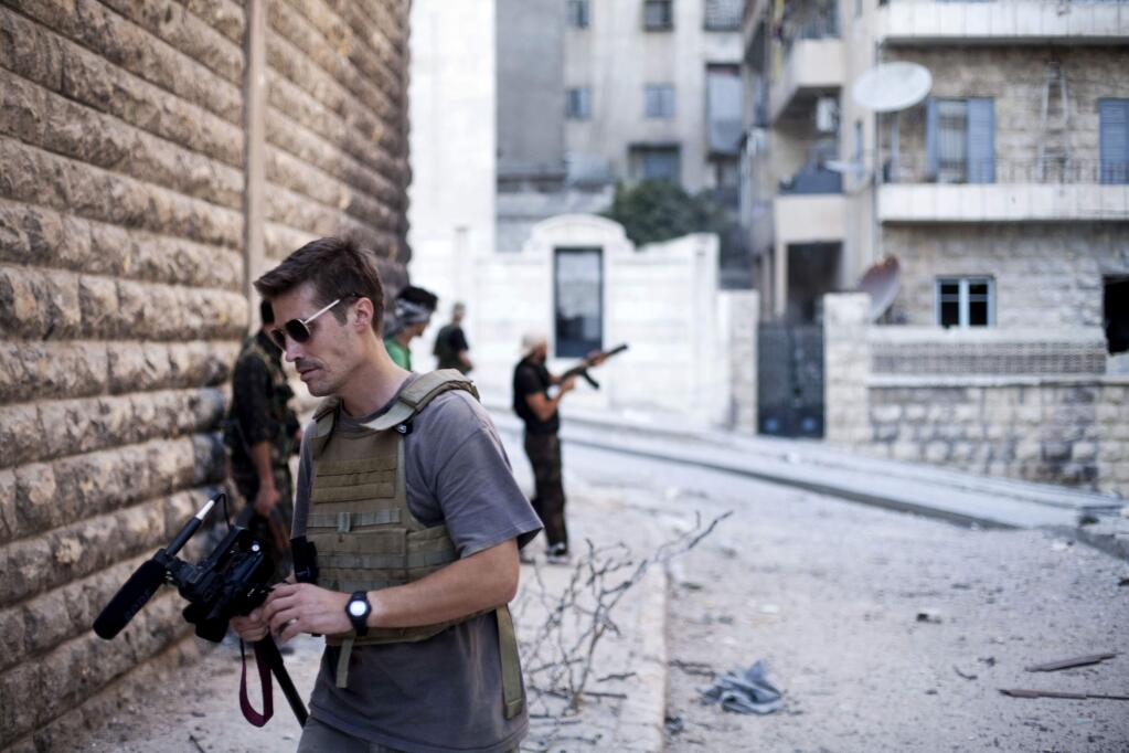 This September 2012 file photo posted on the website freejamesfoley.org shows journalist James Foley in Aleppo, Syria. In a horrifying act of revenge for U.S. airstrikes in northern Iraq, militants with the Islamic State extremist group have beheaded Foley, and are threatening to kill another hostage, U.S. officials say. (AP Photo/freejamesfoley.org, Manu Brabo, File)