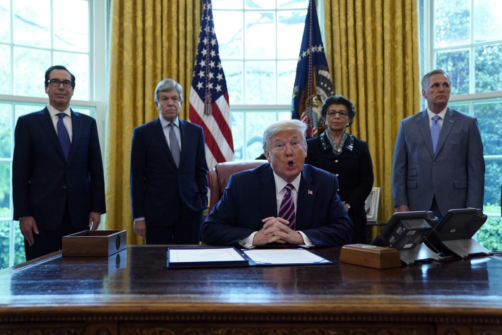 President Donald Trump speaks before signing a coronavirus aid package to direct funds to small businesses, hospitals, and testing, in the Oval Office of the White House, Friday, April 24, 2020, in Washington. (AP Photo/Evan Vucci)