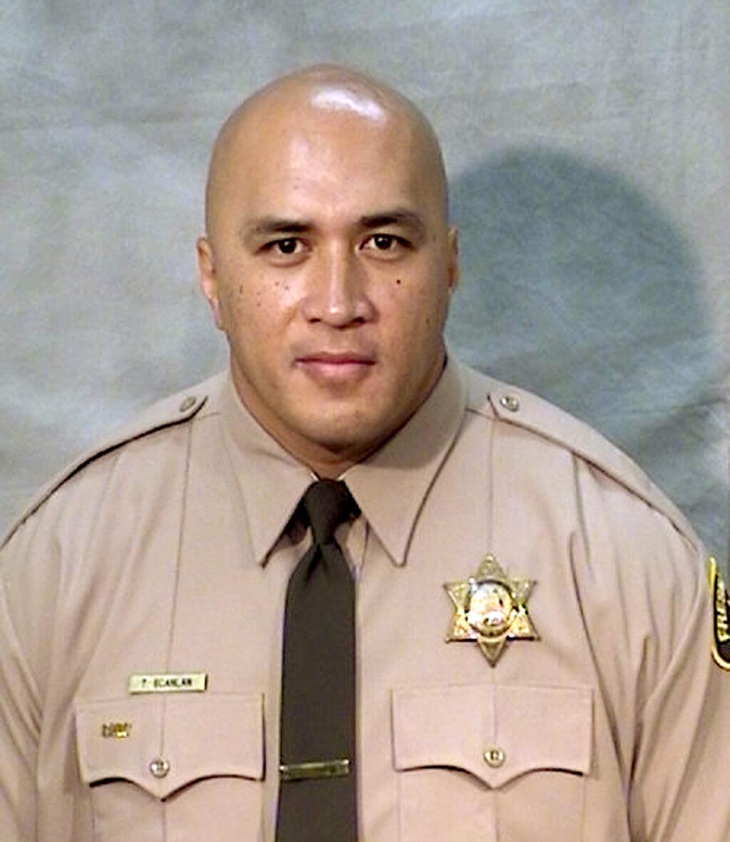 This undated photo provided by the Fresno County Sheriff's Office shows corrections officer Toamalama Scanlan. He was one of two unarmed officers critically injured after a man opened fire in the main lobby of the Fresno County Jail in downtown Fresno, Calif., Saturday, Sept. 3, 2016. Authorities said officers from the secured areas inside the jail ran to the lobby, where a lieutenant fired shots at the gunman, identified as 37-year-old Thong Vang, who was taken into custody. The injured officers were dragged out of the lobby and taken to the hospital to undergo surgery. (Fresno County Sheriff's Office via AP)