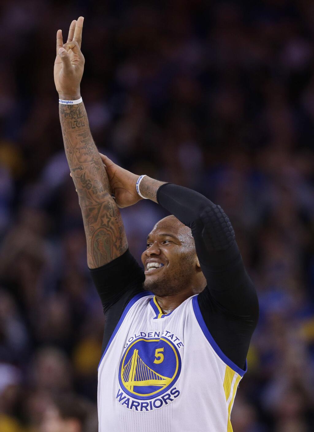 Golden State Warriors' Marreese Speights (5) celebrates after making a 3-point basket during the first half of a game against the New Orleans Pelicans Friday, March 20, 2015, in Oakland. (AP Photo/Marcio Jose Sanchez)