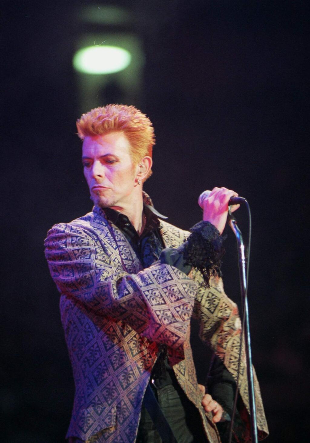 FILE - In this Jan. 9, 1997, file photo, David Bowie performs during a concert celebrating his 50th birthday, at Madison Square Garden in New York. Bowie, the innovative and iconic singer whose illustrious career lasted five decades, died Monday, Jan. 11, 2016, after battling cancer for 18 months. He was 69. (AP Photo/Ron Frehm, File)