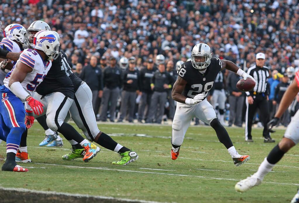 Oakland Raiders running back Latavius Murray looks for a gap in the Buffalo Bills defense during their game in Oakland on Sunday, December 4, 2016. The Raiders defeated the Panthers 38-24.(Christopher Chung/ The Press Democrat)