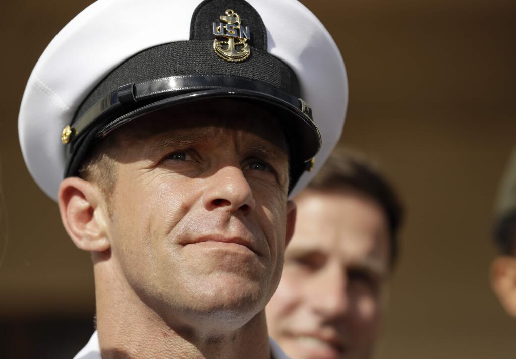 FILE - In this July 2, 2019, file photo, Navy Special Operations Chief Edward Gallagher leaves a military court on Naval Base San Diego in San Diego. President Donald Trump says he has directed the secretary of the Navy and chief of naval operations to “immediately withdraw and rescind” the Navy Achievement Medal from prosecutors who argued the case against Gallagher, a decorated Navy SEAL. Military jurors earlier this month acquitted Gallagher in the death of a wounded Islamic State captive under his care in Iraq. (AP Photo/Gregory Bull, File)