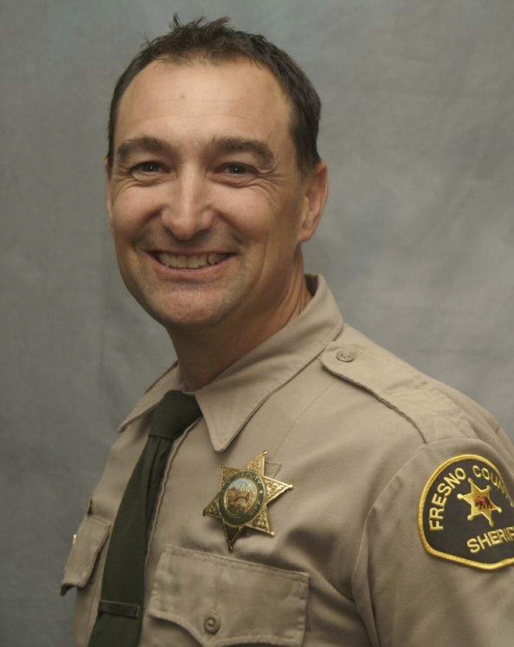 In this undated photo released by the Fresno County Sheriff's Office is Deputy John Erickson. Authorities say a man suspected of shooting the Fresno County Sheriff's deputy who responded to a call about two neighbors arguing over a rural property boundary was arrested after a standoff. The Fresno Bee reports Fresno County Sheriff Margaret Mims says the suspect was arrested Tuesday, July 2, 2019, on suspicion of shooting of 49-year-old Deputy Erickson near the community of Tollhouse, Calif. (Fresno County Sheriff's Office via AP)