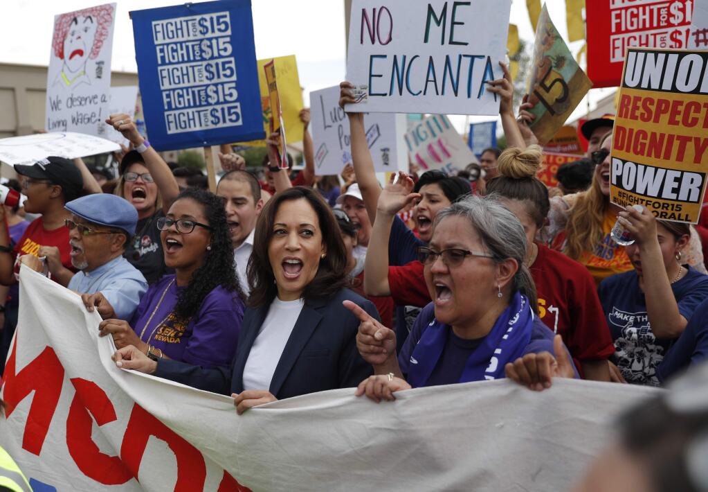Democratic presidential candidate Sen. Kamala Harris, center left, D-Calif., marches with people protesting for higher minimum wage outside of McDonald's, Friday, June 14, 2019, in Las Vegas. (AP Photo/John Locher)
